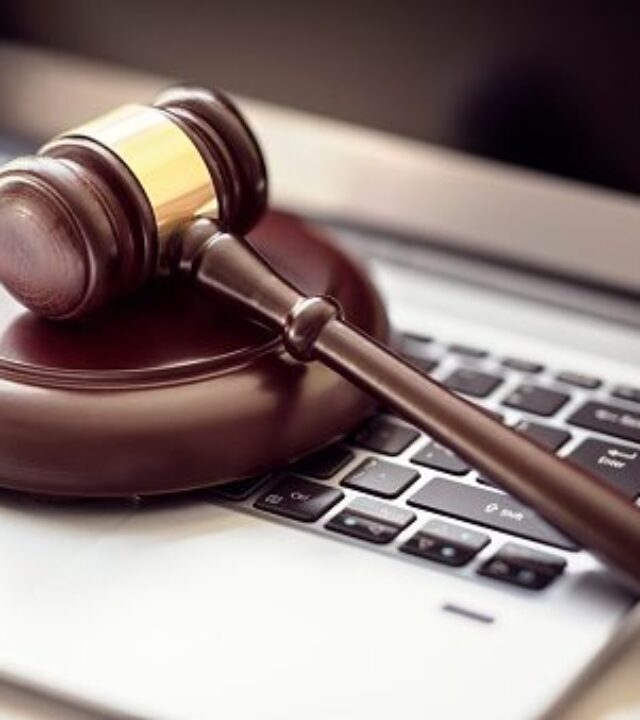 Gavel on laptop computer keyboard concept for online internet auction or legal attorney assistance